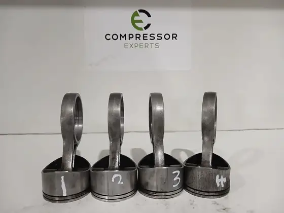 Pistons and connecting rods laid out for inspection