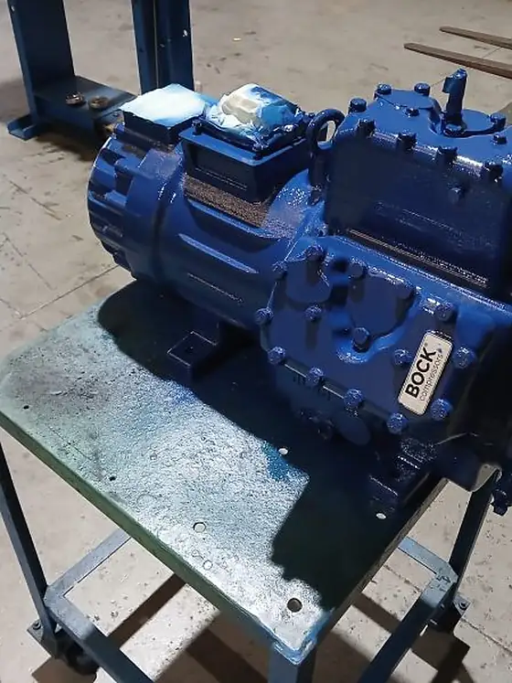 A BOCK semi-hermetic compressor mounted on a workshop bench