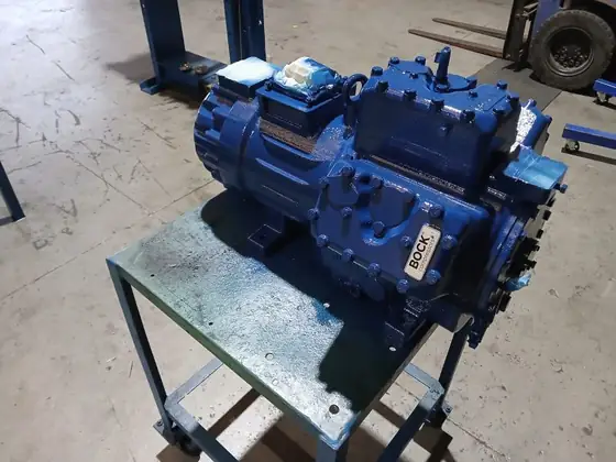 A BOCK semi-hermetic compressor mounted on a workshop bench