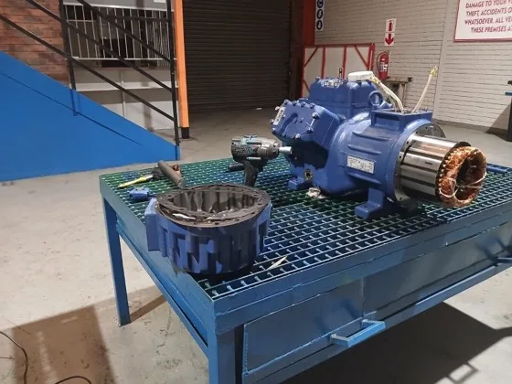 A BOCK reciprocating compressor with stator and rotor pulled for a motor rewind