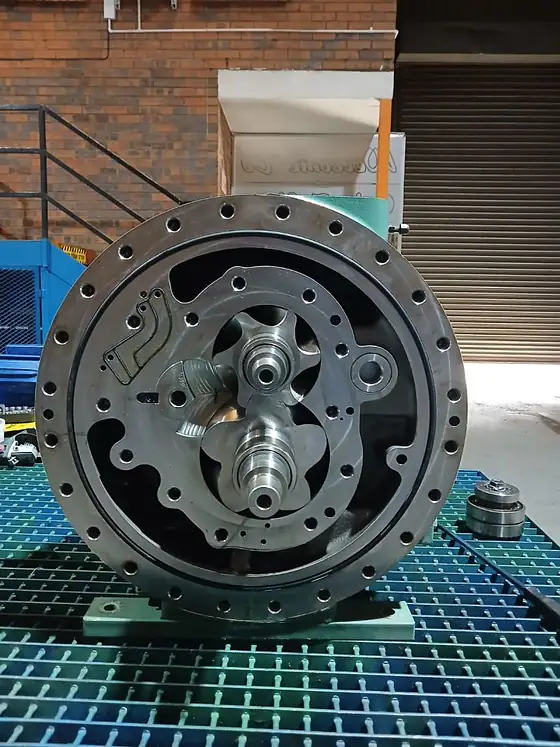 A semi-hermetic screw compressor on workshop grating